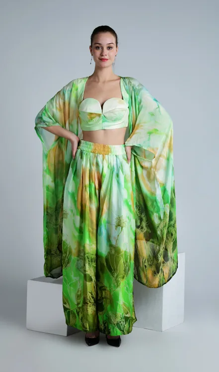 Female model standing confidently in a green printed co-ord set for a fashion photoshoot pose