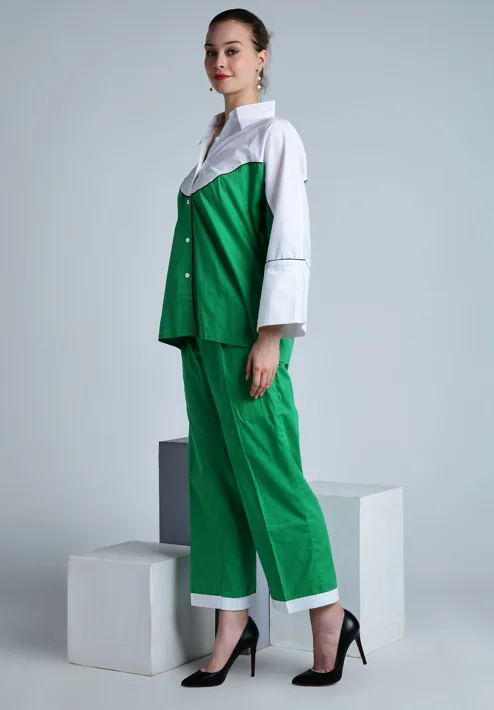 Female model in a side-profile stance wearing a green and white outfit for fashion photography